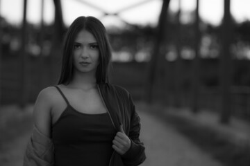 Portrait of a beautiful girl with flowing hair and a black background. Black and white photography concept.