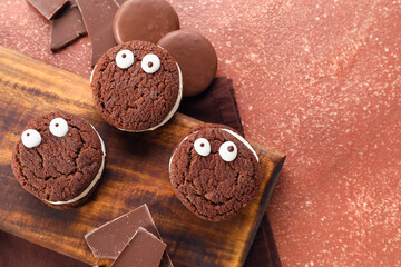 Funny chocolate cookies on color background