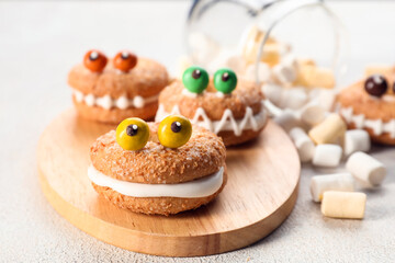 Funny cookies with marshmallows on table