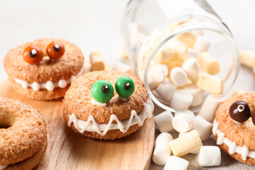 Funny cookies with marshmallows on table