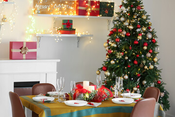 Dining table with beautiful setting in living room decorated for Christmas eve
