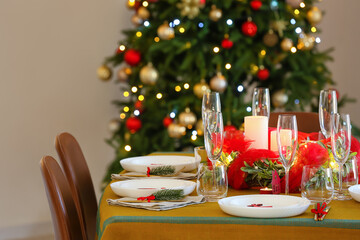 Dining table with beautiful setting in living room decorated for Christmas eve
