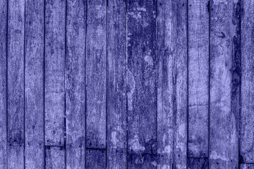Fototapeta na wymiar Trendy Color of Year. Very peri. 2022. fence made of wood. Wooden background with weathered wood.