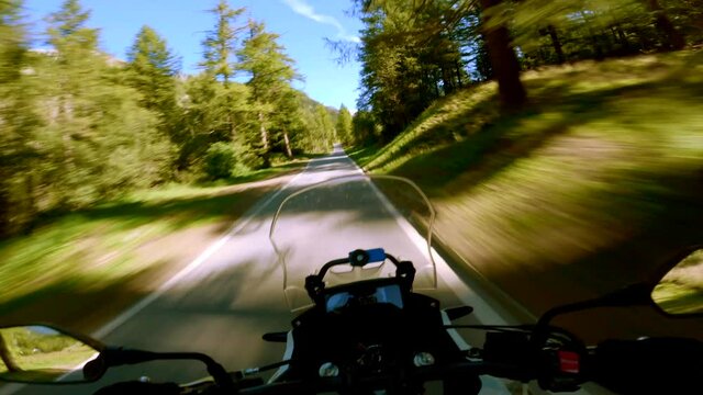 A highway motorcycle ride on a sunny summer day, at the Simplon Pass in Switzerland.