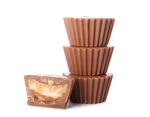 Tasty peanut butter cups on white background