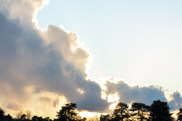 Weird face appears in clouds at sunset - stock photo