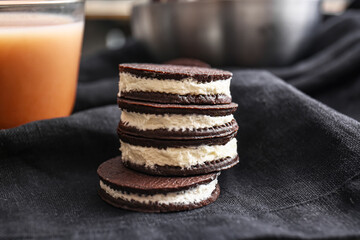 Tasty chocolate cookies with cream on table, closeup