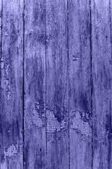 Trendy Color of Year. Very peri. 2022. old fence with paint residues. Cracked blue paint