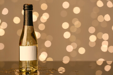 Bottle of champagne on table against blurred background