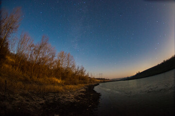 milky way and moonny forest forest in the night . Night landscape. Nightsky and clouds . Stars in the sky . 