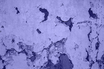 Trendy Color of Year. Very peri. 2022. old white cracked wall of clay houses with peeling paint