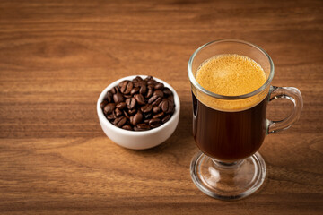 Espresso and coffee beans on the table.