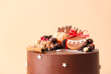 Tasty Christmas chocolate cake on beige background, closeup