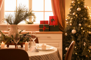 Dining table with festive setting for Christmas celebration in kitchen interior