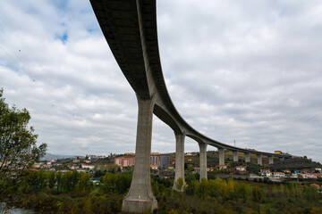 View on Douro river bridges near Peso da Regua and colorful hilly stair step terraced vineyards in...