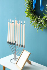 Menorah on table in room decorated for Hanukkah celebration