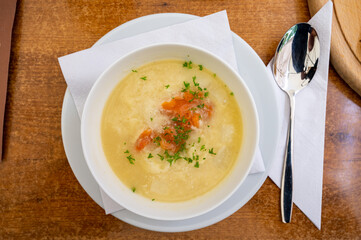 Seasonal dish, white asparagus cream soup with smoked salmon fish