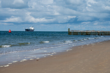 Walking on white sandy beach North sea beach near Zoutelande, Zeeland, Netherlands