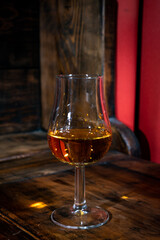 Glasses of strong scotch single malt whisky served on dark wooden table in old pub