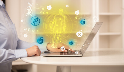 Doctor working on laptop with healthcare concept