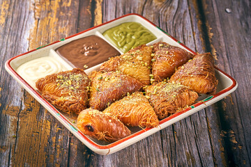 Arabian Traditional Desserts - Cream and cheeses with pistachio flavor and nuts on top