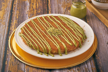 Traditional Arabian sweets  with Cream and Cheese with nuts and flavor on top on wood background