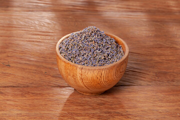 Lavandula - Wooden Bowl with Lavender Flower Seeds; Photo On Wooden Background