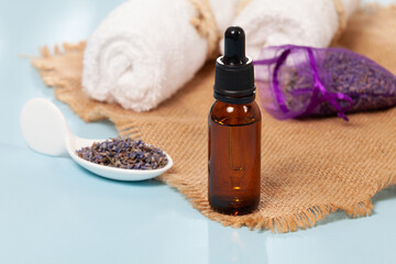 Fototapeta na wymiar Lavandula - Organic Lavender Essential Oil in Glass Bottle with Dried Flowers