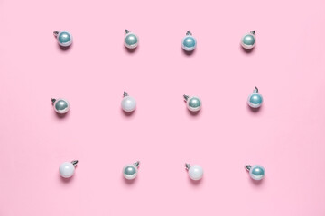 Different Christmas balls on pink background