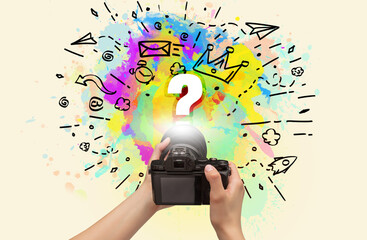 Close-up of a hand holding digital camera with abstract drawing concept