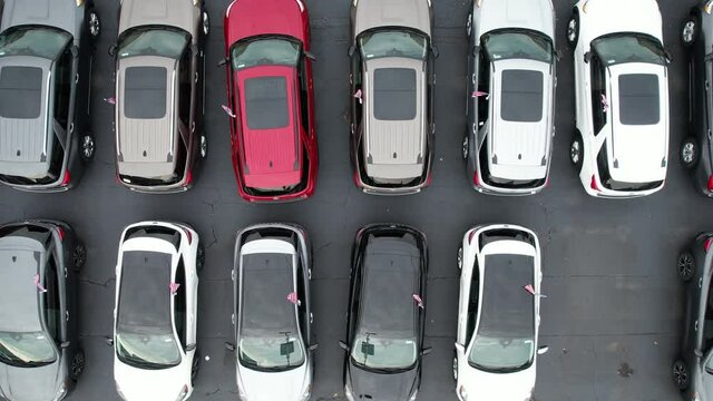 Rows of Brand New Car in an American Dealerships Stock Aerial View. Automotive Industry Theme.
