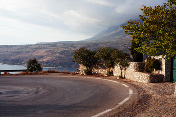 beautiful landscape in greek mountains: route on road with sea line