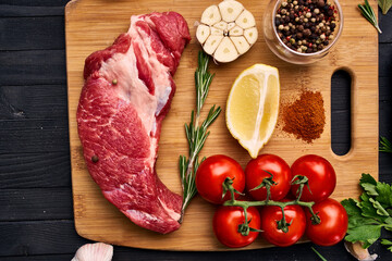 meat vegetables ingredients on a wooden board beef