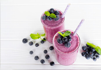 Blueberry Juice smoothies drink in a glass drink purple colorful fruit juice milkshake blend beverage healthy high protein the taste yummy in glass on white wood background.