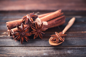 Star anise and cinnamon stick on wooden background