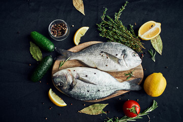 sea fish fresh ingredients lemon on wooden board
