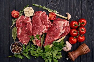 meat on wooden board vegetables and ingredients for cooking wooden background