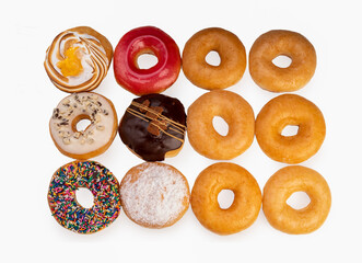 1 dozen mixed donuts, original flavor, chocolate, marmalade and fancy toppings on white background.