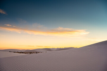 Fototapeta na wymiar Setting Sun Makes The Horizon Glow Gold At White Sands