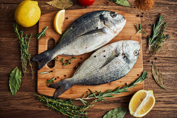 sea fish fresh ingredients lemon on wooden board