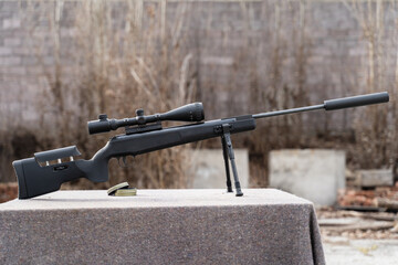 Black polymer frame modern Air gun with optics on the table outdoor
