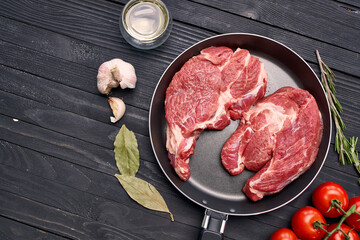 meat steak in a frying pan food ingredients kitchen wooden table