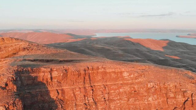 Flight over the top of the cliff in the rays of the evening sun. Evening light and silence. Tepsei Khakassia. Tepsey