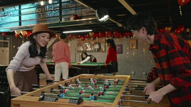 Happy young friends playing table football,4K
