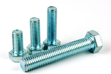 Large silver metal bolts. Close-up on a white background. A group of several metal bolts
