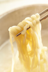 pick up noodles with chopsticks