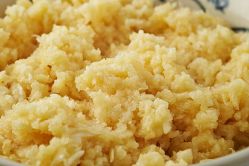 Close-up of fresh minced garlic in a bowl