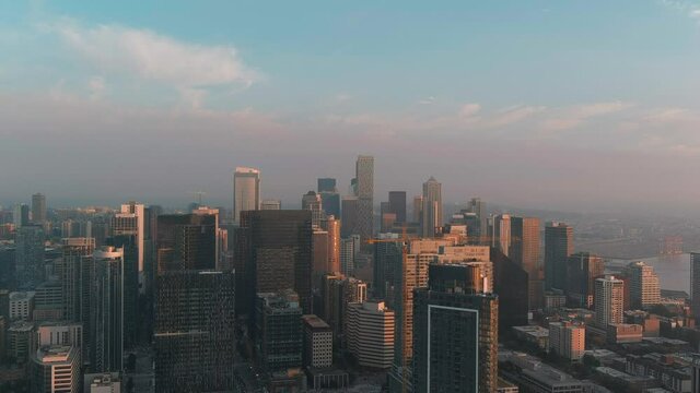 Wide aerial shot of Seattle's downtown skyline during sunset.