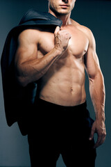 Fototapeta na wymiar man with muscular torso workout fitness dark background