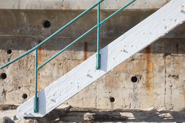 Side view of wooden stair case with metal railings outside